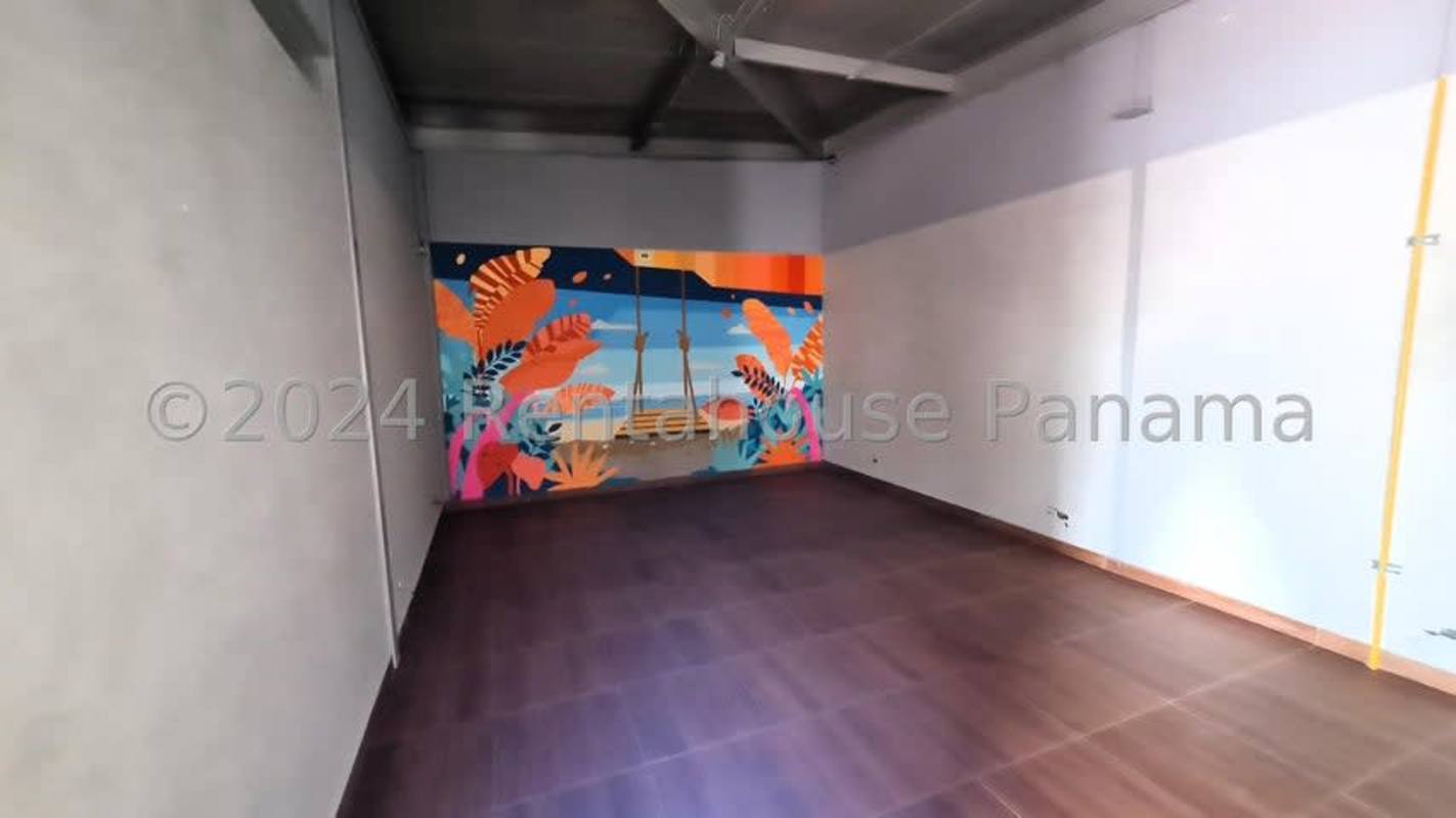 Large open multipurpose space with artistic mural suitable for events or seating in commercial rental Panama
