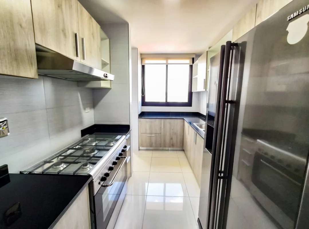 Contemporary kitchen with window, appliances, cabinetry at PH Cosmopolitan Panama