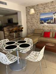 Modern open-plan living dining area with accent wall, PH Mosaic Panama Pacifico apartment for rent