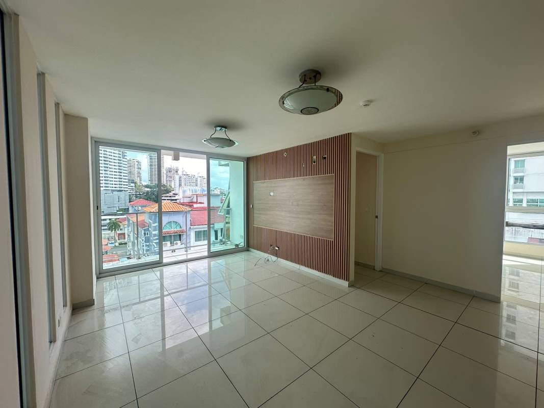 Spacious living room with floor-to-ceiling windows city skyline view and ceramic flooring at PH Bella Vista Panama City