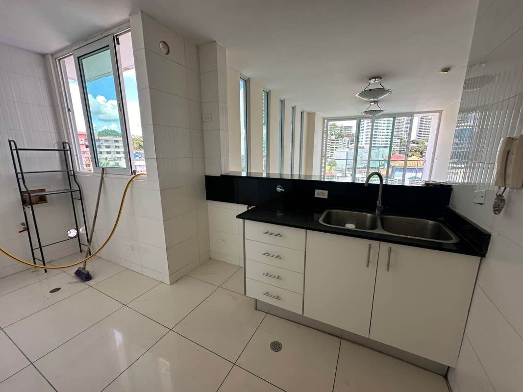 Kitchen space features black granite countertops white cabinetry windows PH Bella Vista Panama City