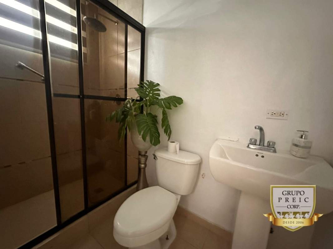 Modern bathroom with glass shower and natural light PH El Cangrejo Panama