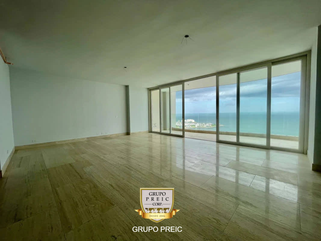 Bright spacious living-dining area with marble flooring and panoramic glass doors overlooking Pacific Ocean Punta Paitilla