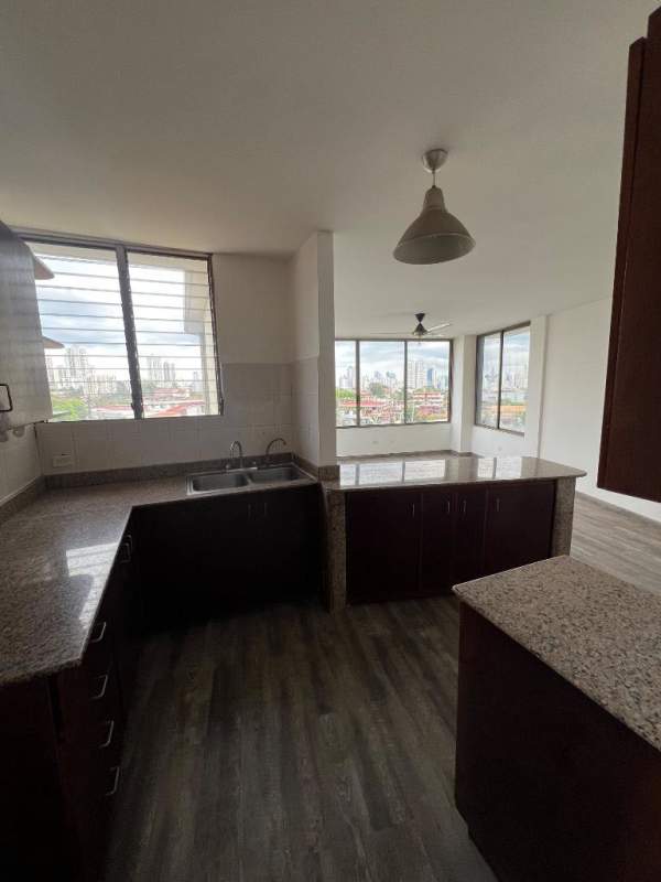 Kitchen with granite countertops, dark cabinetry, large windows PH Miraflores Tower Panama