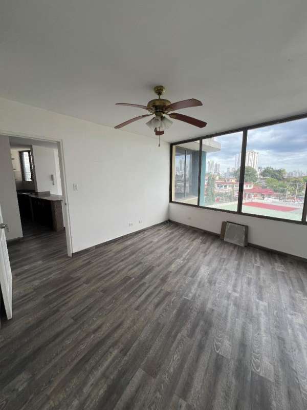 Living area with ceiling fan, large windows at PH Miraflores Tower Villa de las Fuentes Panama