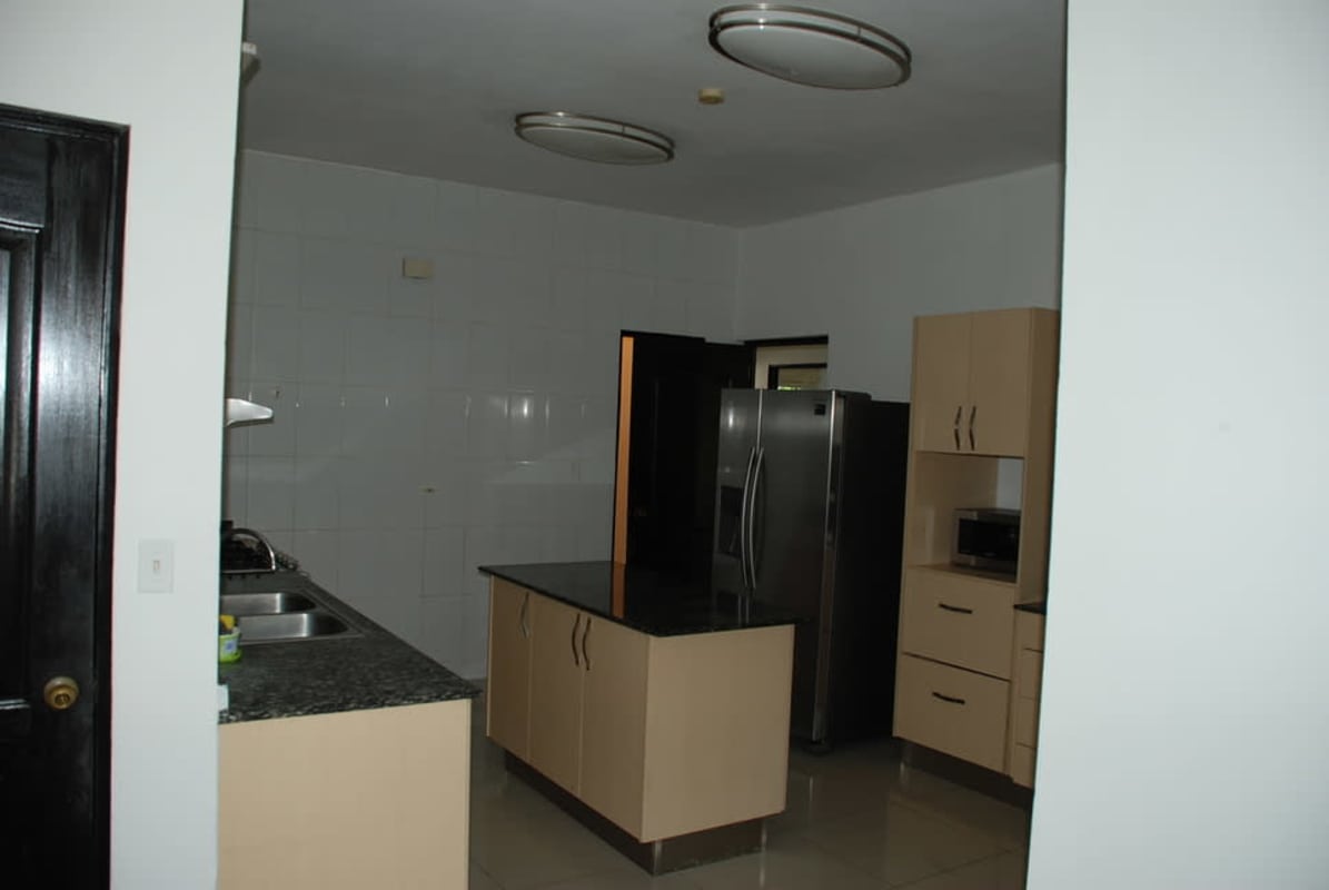 Full bathroom with tiled shower, small window and granite vanity at Costa Sur house