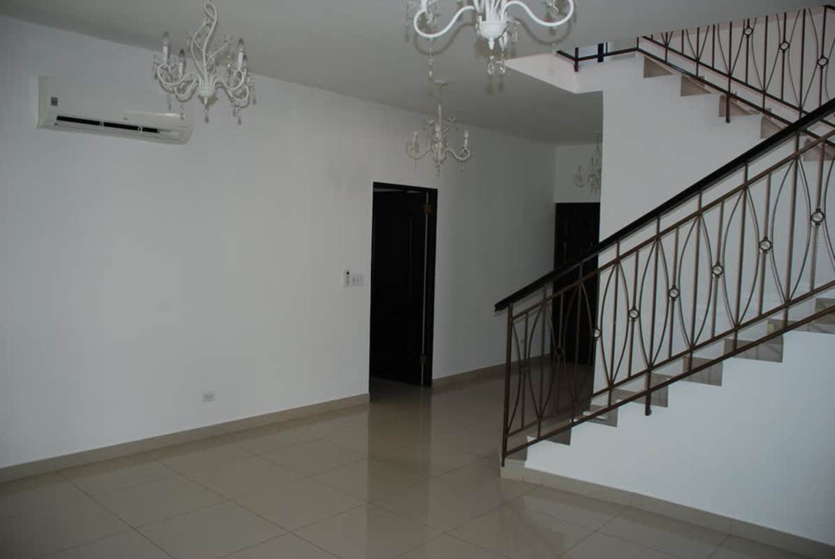 Modern kitchen featuring granite countertops, beige cabinets, stainless appliances at Costa Sur house