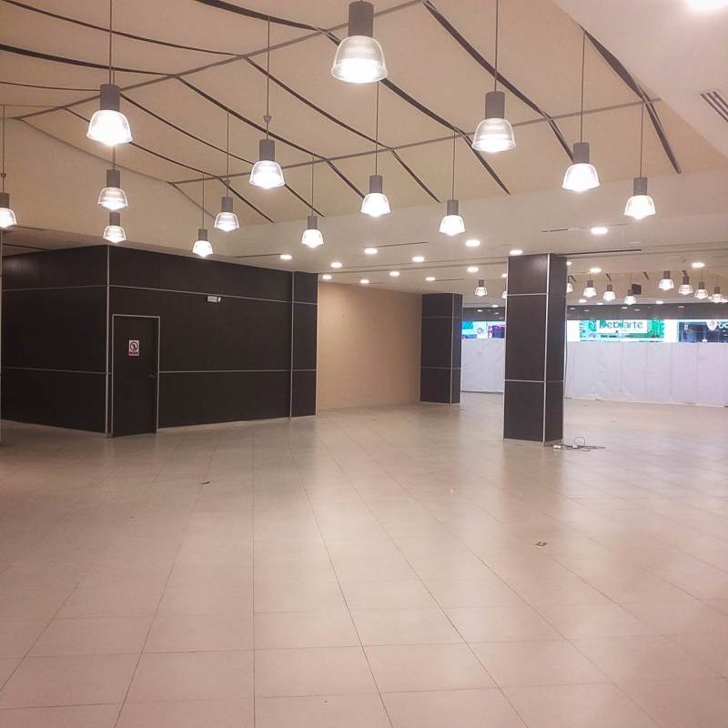Modern commercial retail space interior with tile flooring and lighting at Albrook Mall