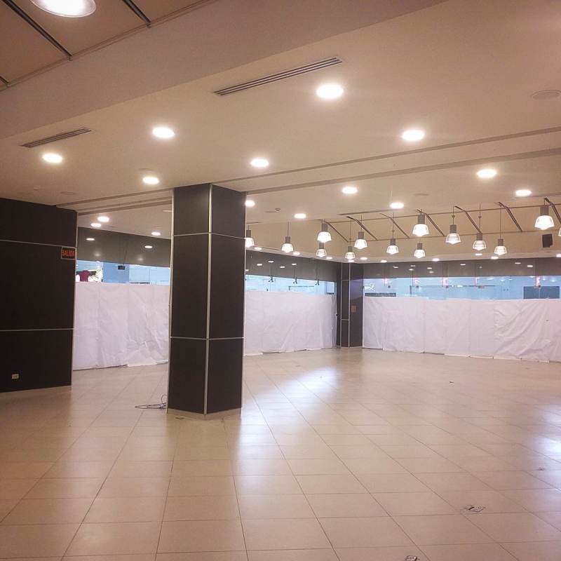 Interior of Albrook Mall with stores, kiosks, and decorative sculptures in Panama