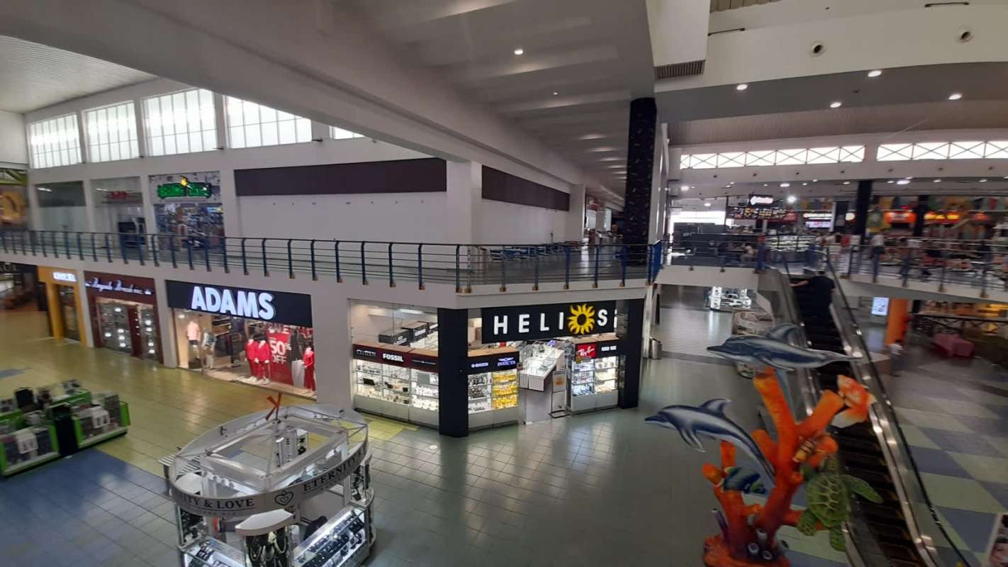 Ground floor of Albrook Mall with stores, kiosks, and sea life decor in Panama City