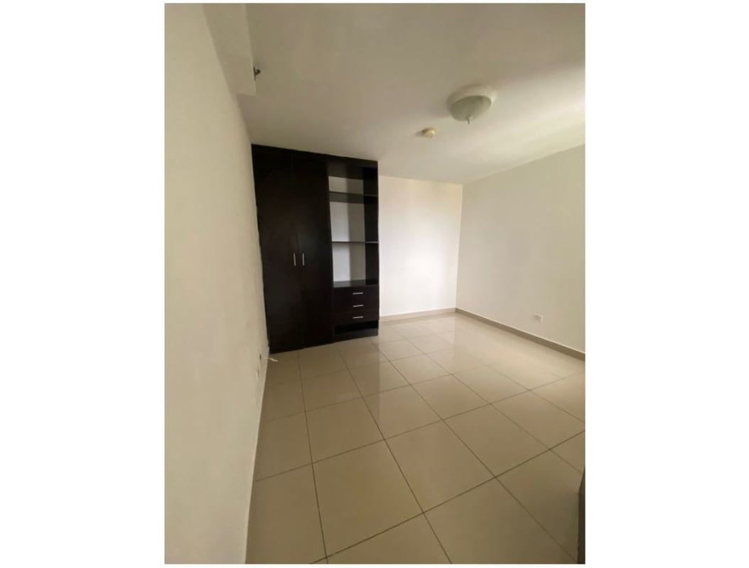 Master bedroom with large window, closet space, tile floor at PH Centennial Parque Lefevre Panama