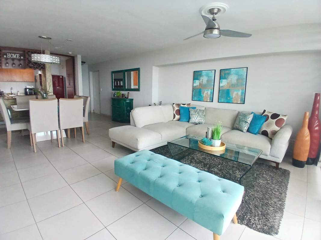Spacious living room with sliding glass doors opening to balcony with panoramic ocean views at PH Terrawind San Francisco Panama City