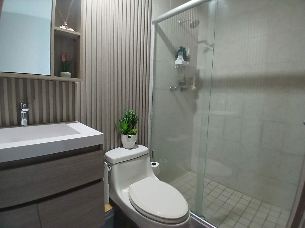 Master bedroom with large window ocean views and ensuite bathroom in PH Terrawind Panama City