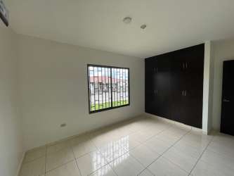 Bedroom with built-in wardrobe air conditioning tile floor in David rental home