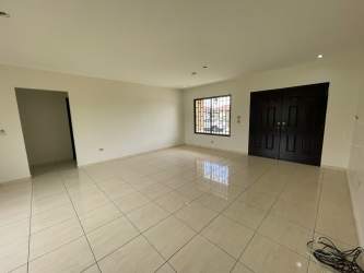 Large empty living space with ceramic tiles white walls double door front entrance David Panama rental