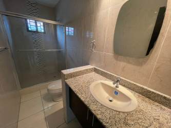 Modern bathroom granite countertop glass shower enclosure rental house David Chiriquí