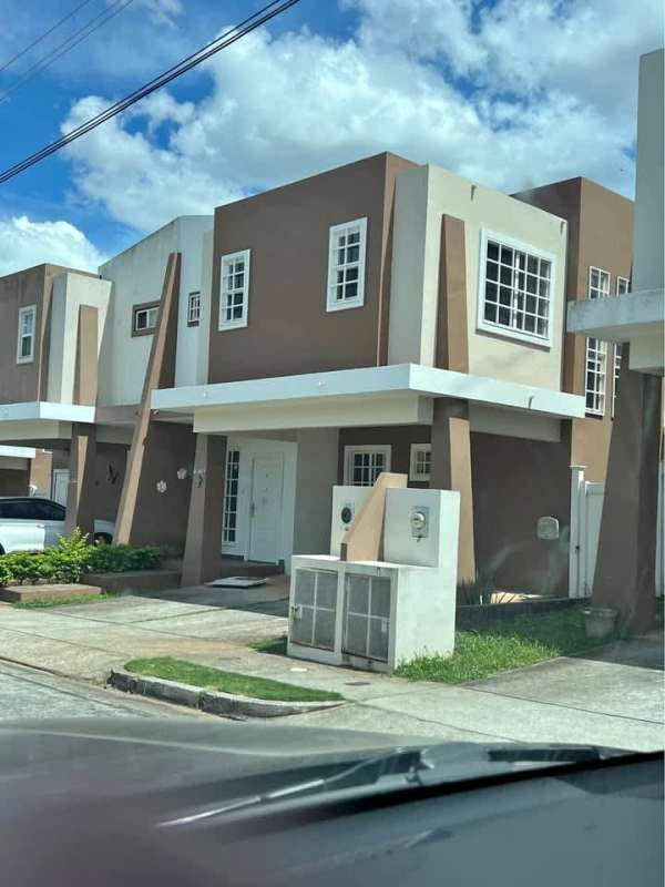 Two-story townhouse facade with driveway and porch at PH Everest in Brisas del Golf Panama City