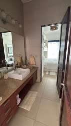 Modern bathroom with double sink vanity and glass shower Punta Barco Village
