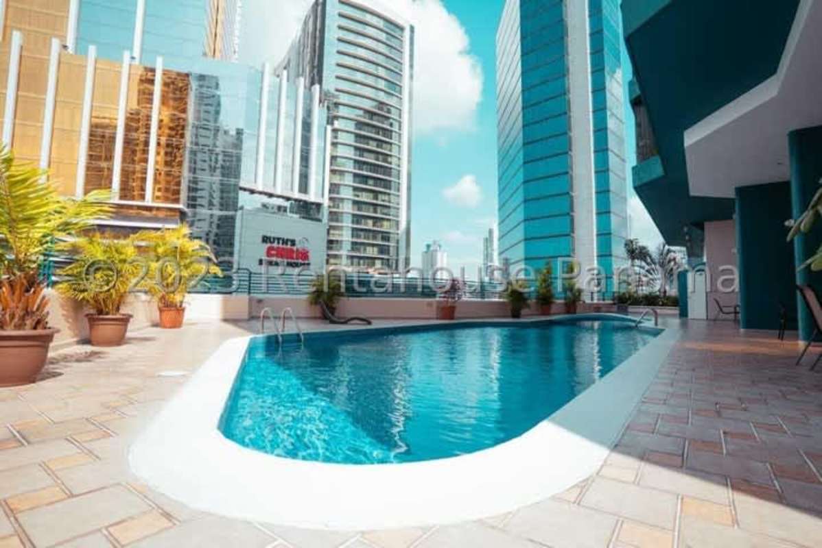 Rooftop pool with potted palms overlooking Panama City skyline in PH Marina Plaza Marbella