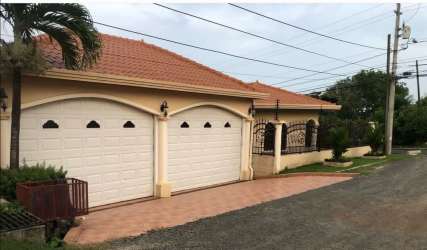 Kitchen with granite countertops, wood cabinetry, built-in appliances and dining nook at Talavera La Chorrera Panama