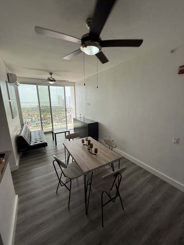 Comfortable bedroom furnished with AC, ceiling fan, wardrobe, view of Panama skyline at Vista Hermosa apartment for rent
