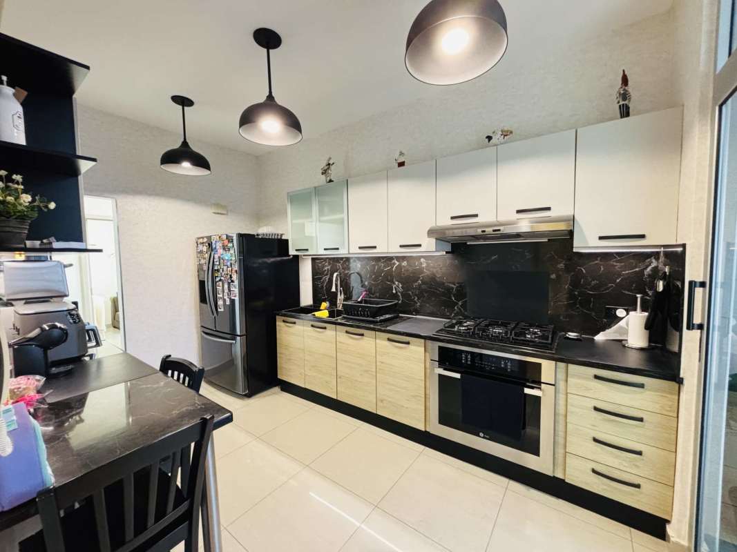 Modern closed kitchen with granite countertop, built-in appliances in Quartz Tower Coco del Mar Panama