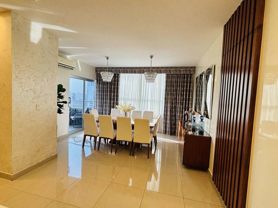 Dining room with large windows, elegant chandelier, open layout in Quartz Tower Coco del Mar Panama