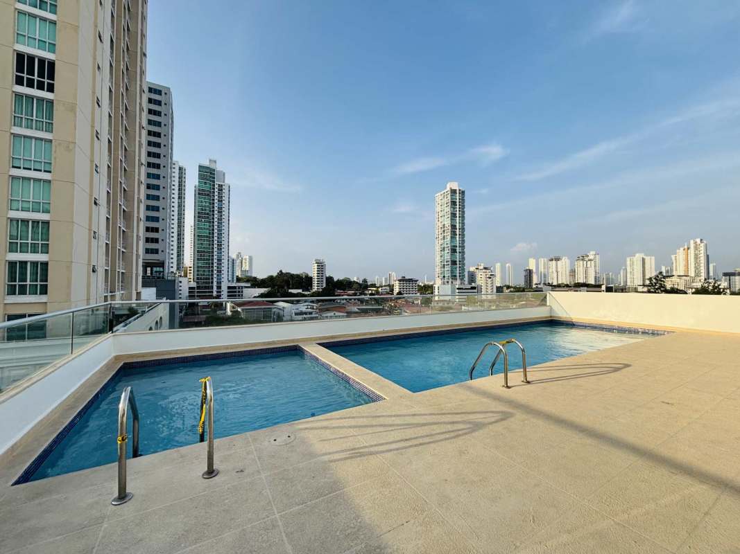 Infinity rooftop pool with glass railing and city skyline at Quartz Tower Coco del Mar Panama