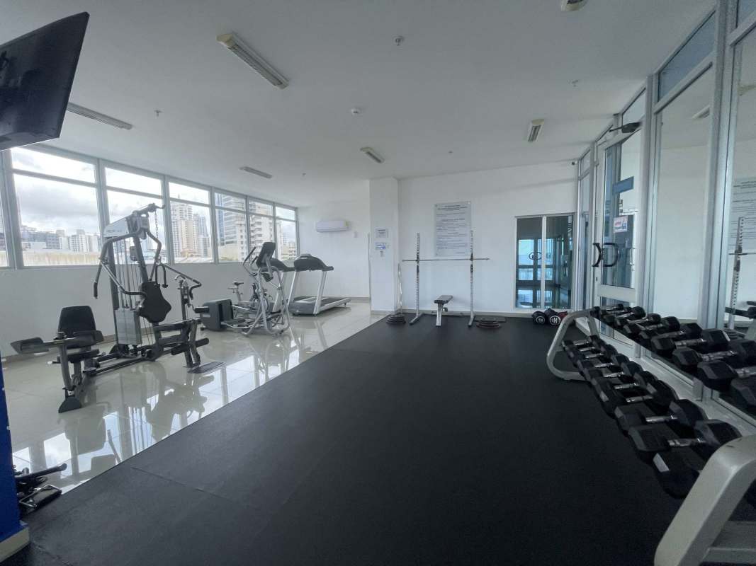 Fully equipped fitness center with cardio and strength training equipment in PH Rainbow Tower Panama