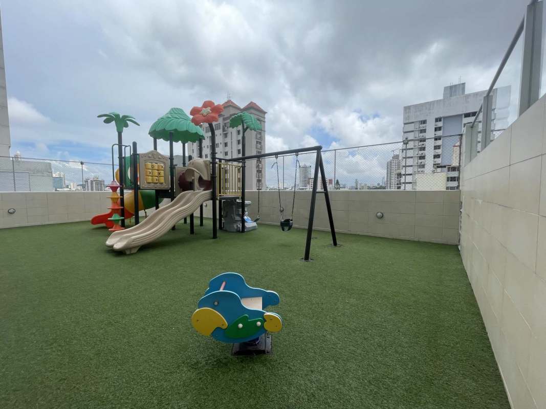 Children's play area with swings slides rooftop PH Rainbow Tower El Carmen Panama