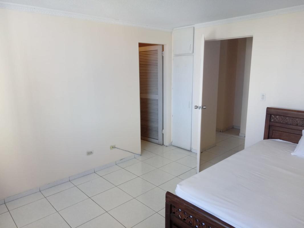 Guest bathroom with glass shower porcelain tiles and sink at PH El Cangrejo Residences