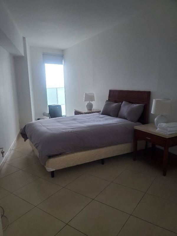 Bedroom with panoramic ocean views, modern decor and balcony access in PH Oasis on the Bay