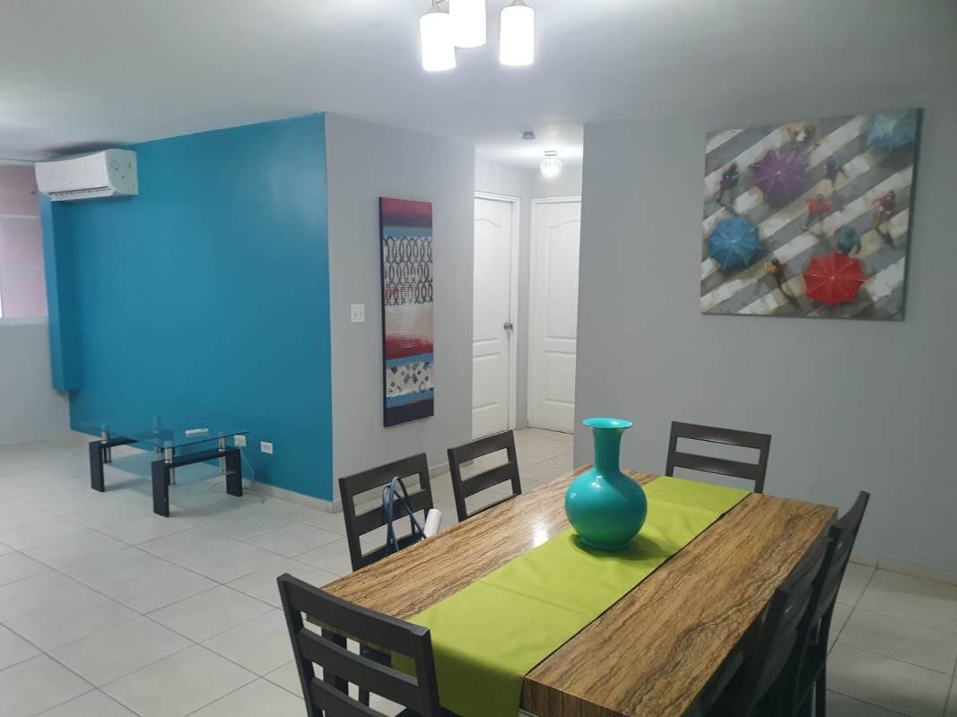 Living and dining area with balcony access, city views at PH San Francisco Bay apartment for rent