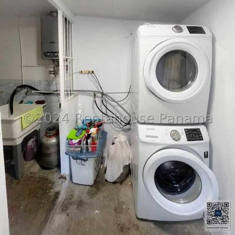 Laundry room with storage and utility sink in Chanis residential house