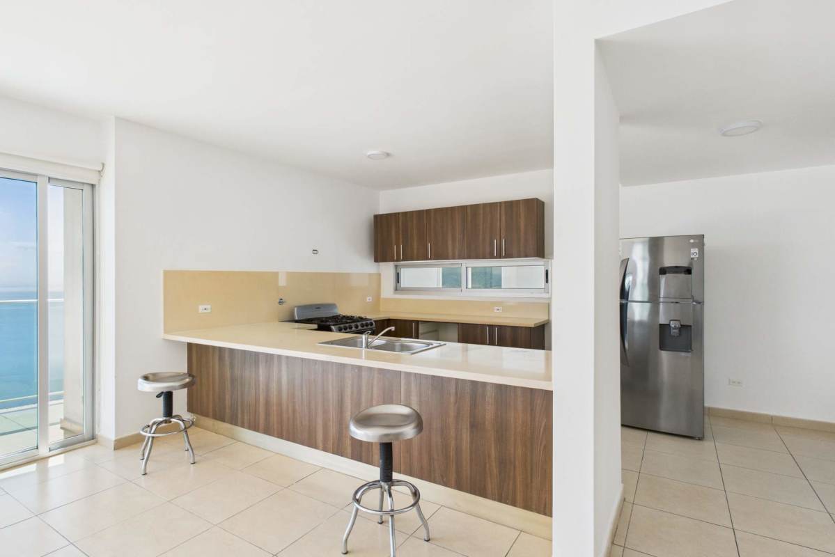 Bright modern living room with sliding doors balcony ocean view in Punta Pacifica Panama