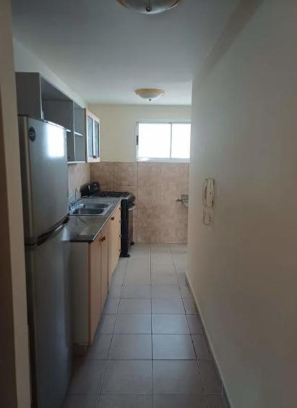 Galley style kitchen with granite countertop, oven and range hood in San Francisco Bay Tower Panama