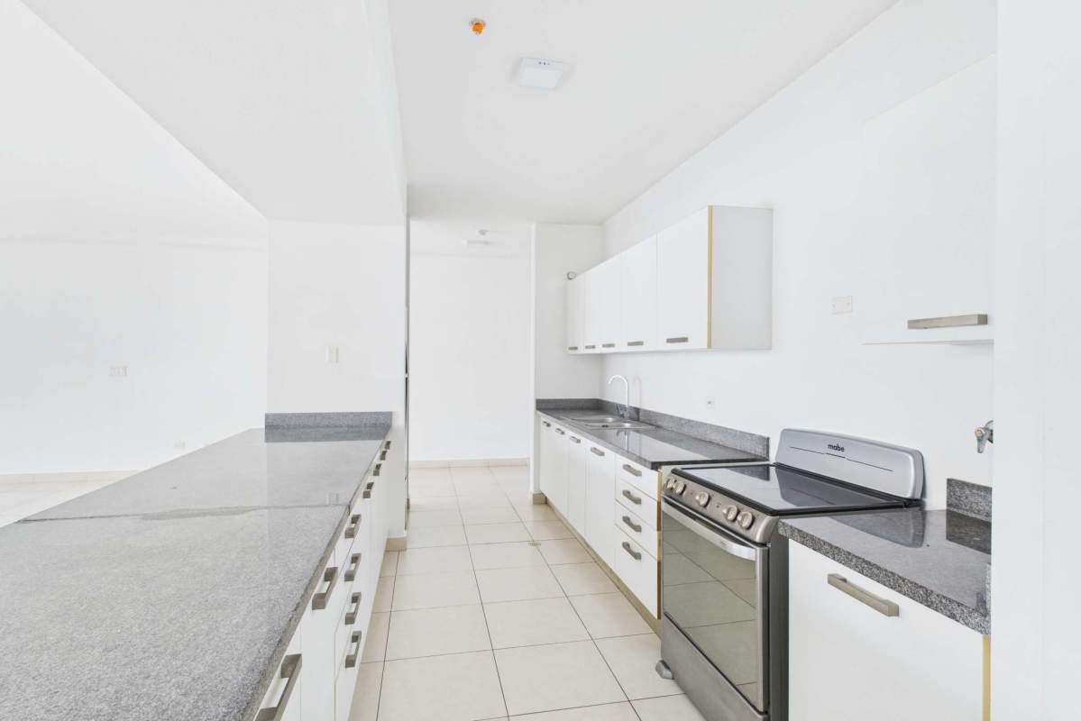Sleek kitchen design with granite countertops steel appliances PH Waters on the Bay Avenida Balboa Panama