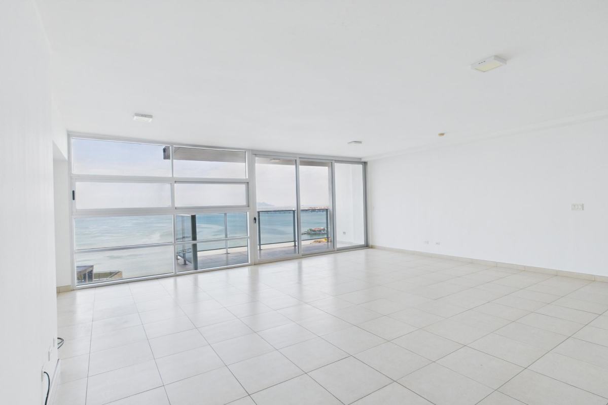 En-suite master bedroom with floor-to-ceiling windows and oceanfront views PH Waters on the Bay