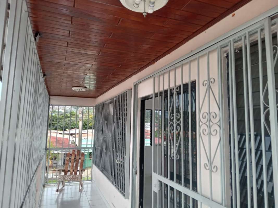 Enclosed balcony with metal security bars, wood ceiling and tile floors Panama