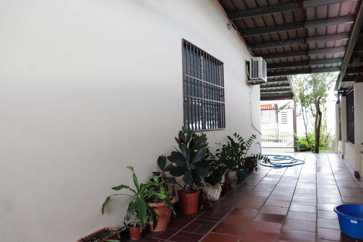 Covered patio with plants and window bars in Punta del Este house for sale Panama
