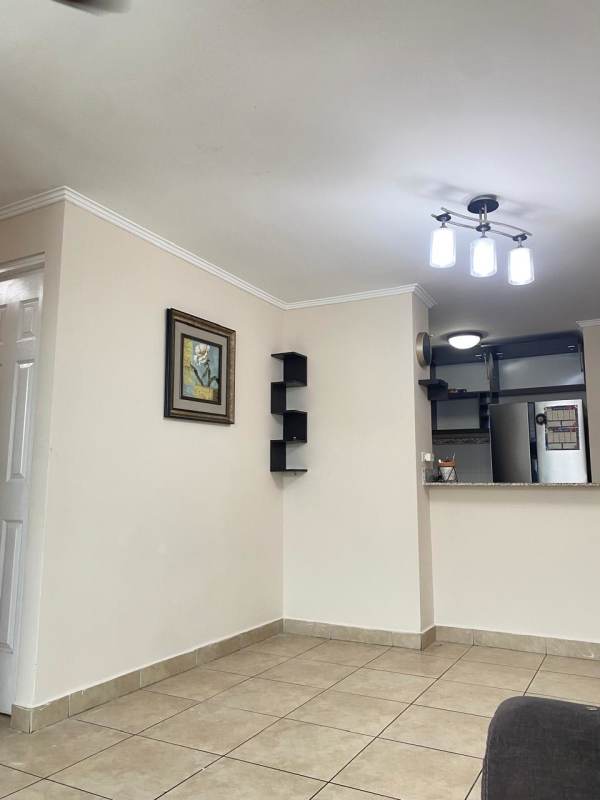 Open plan living area with tile floors and kitchen view PH Residencial Las Palmeras Panama City