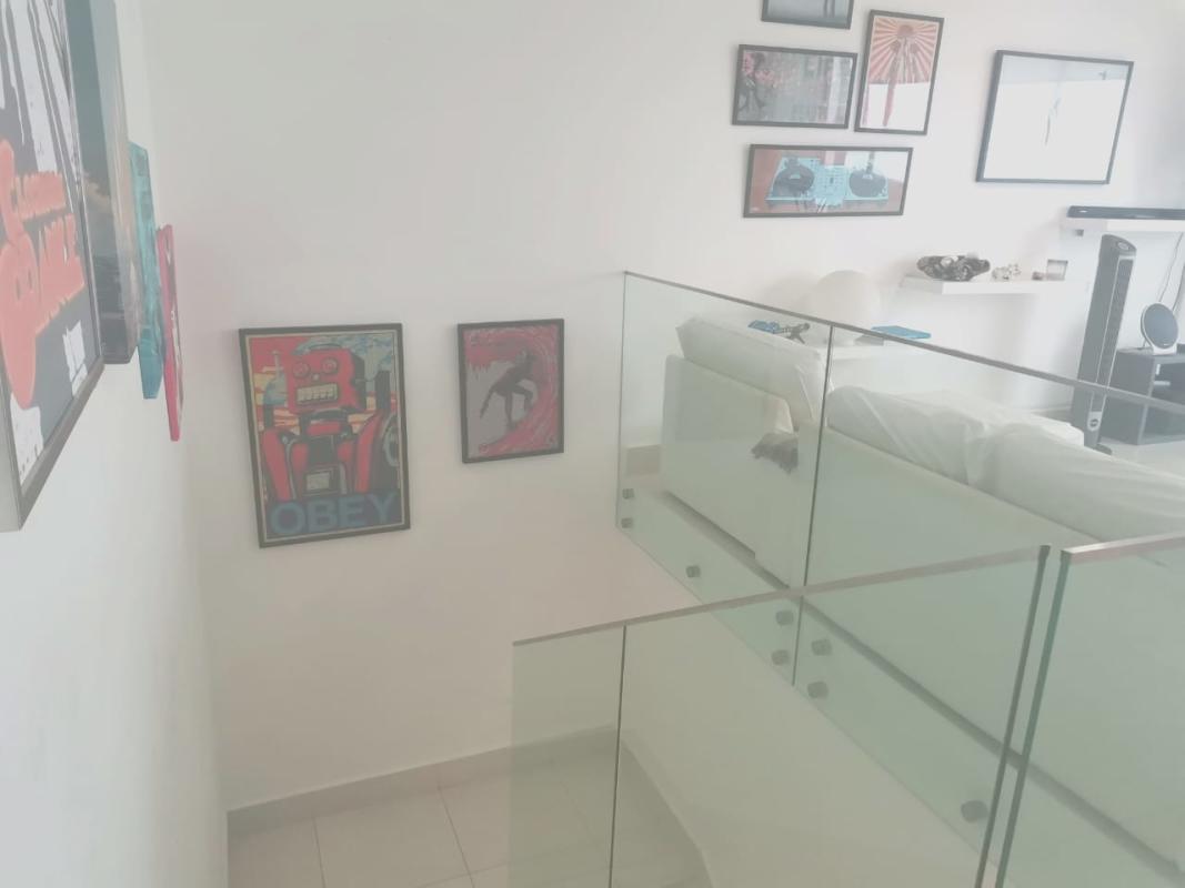 Open kitchen with island, mosaic backsplash, stainless appliances in PH Castellammare Costa del Este Panama