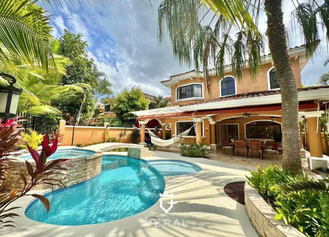Backyard pool with waterfall bridge and lush tropical landscaping Clayton Village