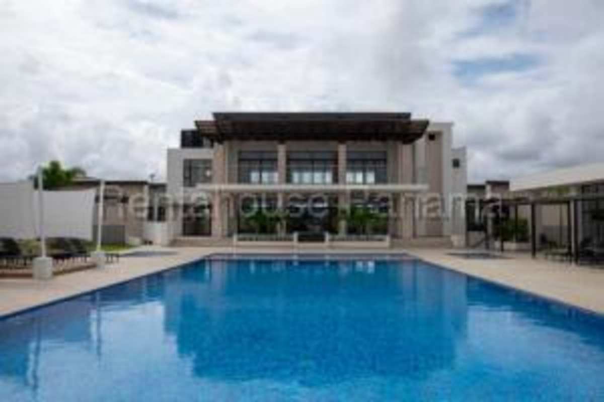 Large swimming pool with cabanas and palm trees in PH Costa Linda Costa Sur Panama City