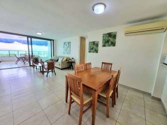 Dining and living space with balcony access at PH Balcones Playa Blanca