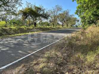 Country asphalt road with green surroundings leading to land near Playa Destiladeros Panama