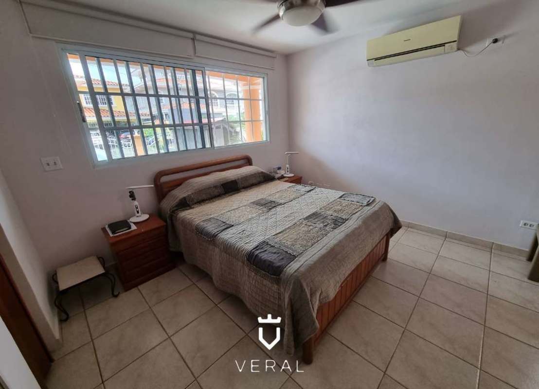 Bright bedroom with large window, closet and ceiling fan for sale in Altos de Panamá