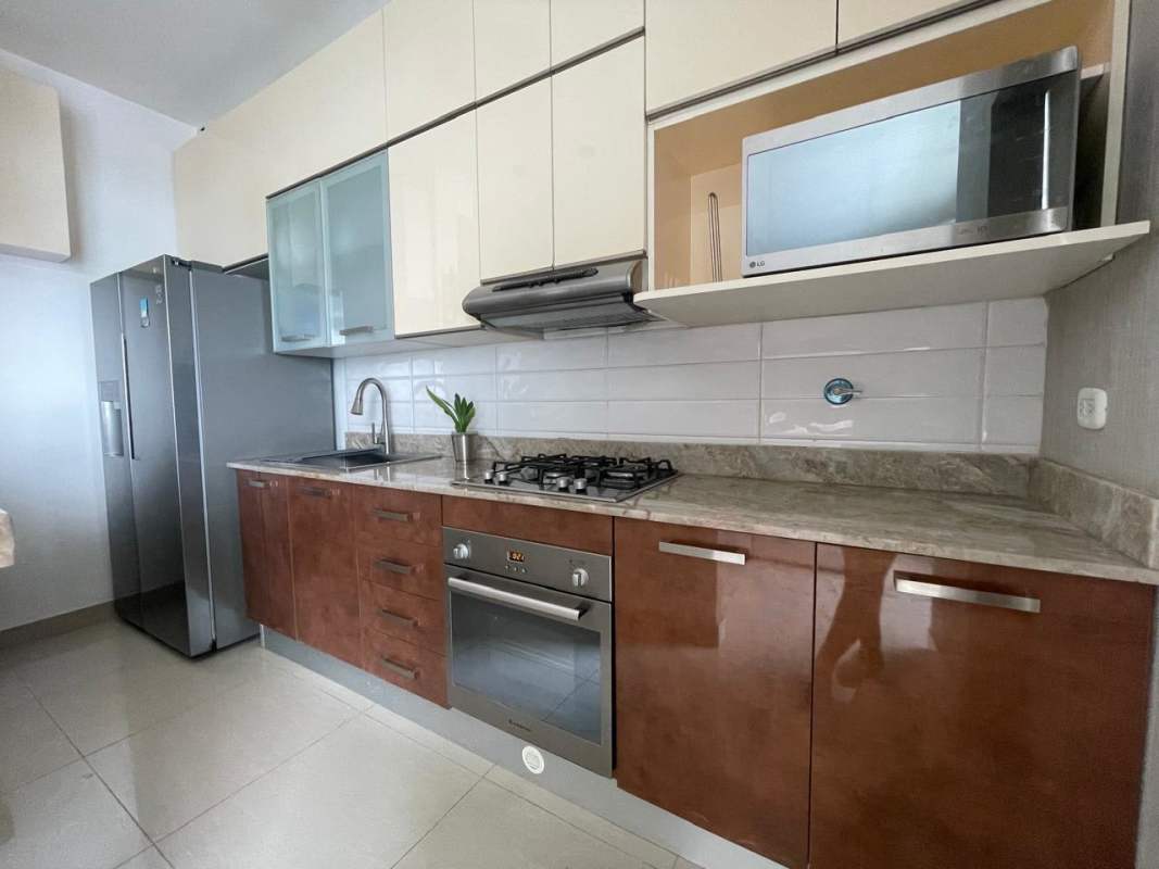 Modern kitchen granite counters, stainless appliances furnished apartment Panama City