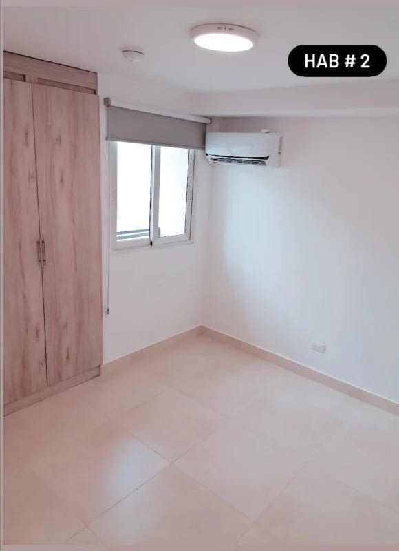 Empty bedroom with closet, AC and roller shade at Panama Viejo Residences Panama