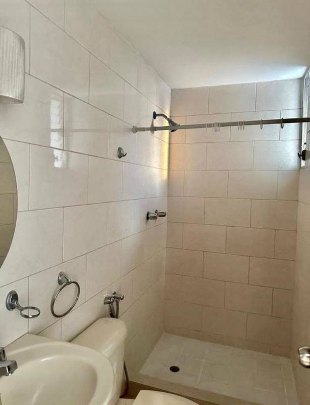 Kitchen with granite counters, stove, microwave, refrigerator, wood cabinets in PH Central Park Panama City